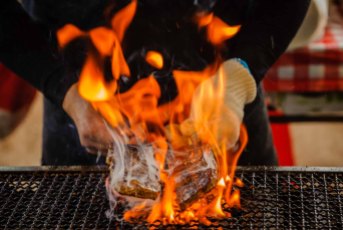 Kushiyaki is engulfed in flames on a grill at the Nagoya Festival. Nagoya photographer Ben Weller.